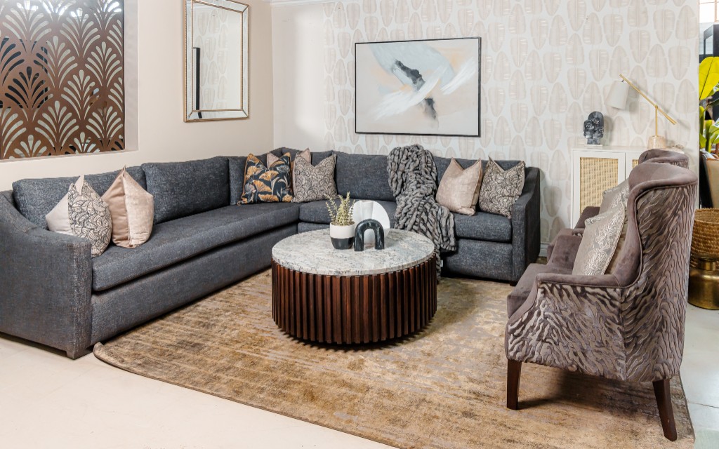 Grey sectional living room with marble coffee table and abstract art