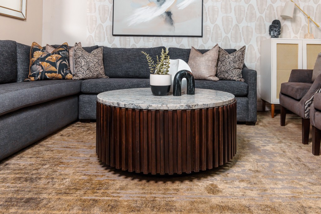 Contemporary lounge with round marble coffee table and patterned cushions